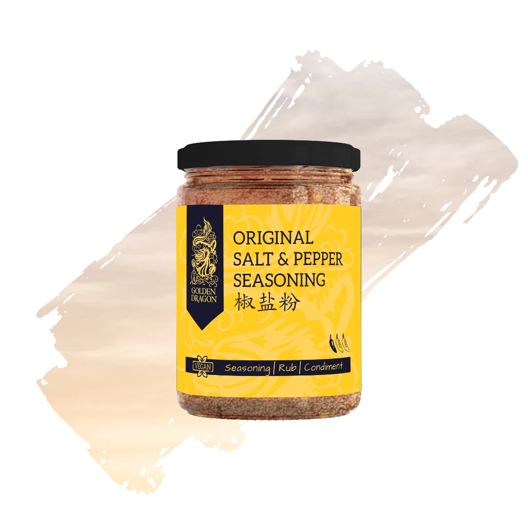 A glass jar of Golden Dragon Original Salt and Pepper Seasoning with a bright yellow label, featuring a black dragon logo and a "Vegan" certification mark.
